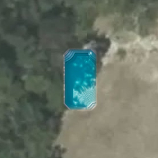 A kidney-shaped pool rendered into a real backyard